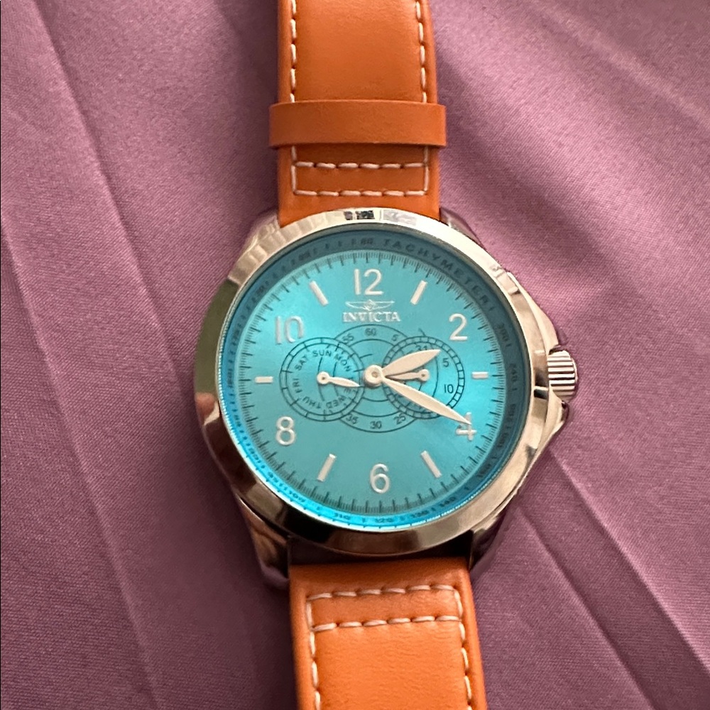 Invicta Timepiece with Aqua Dial and Orange Strap